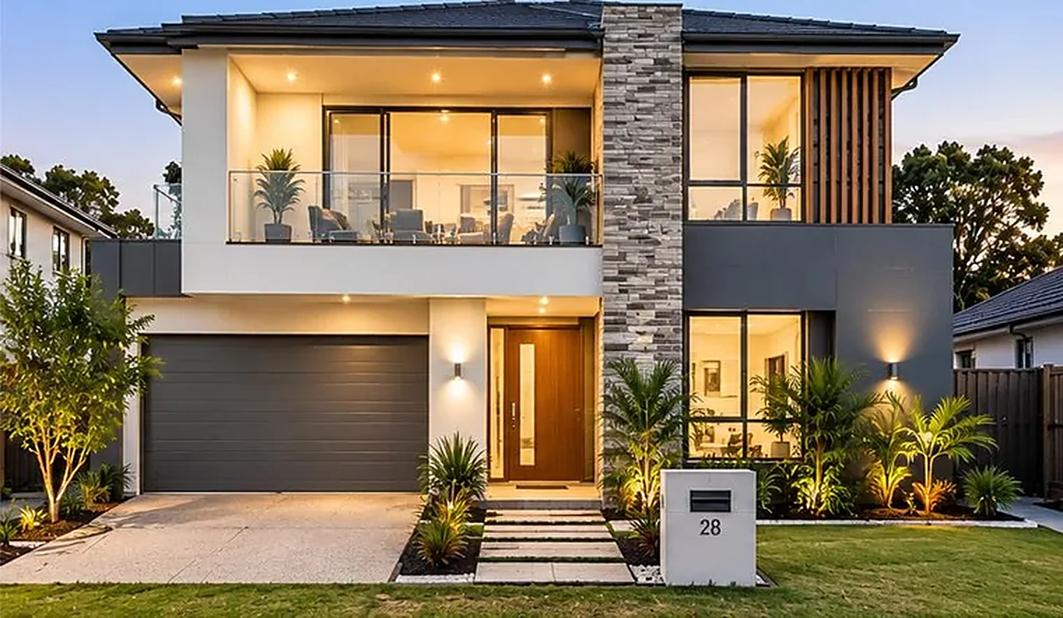 Modern holiday home at dusk with warm lights on